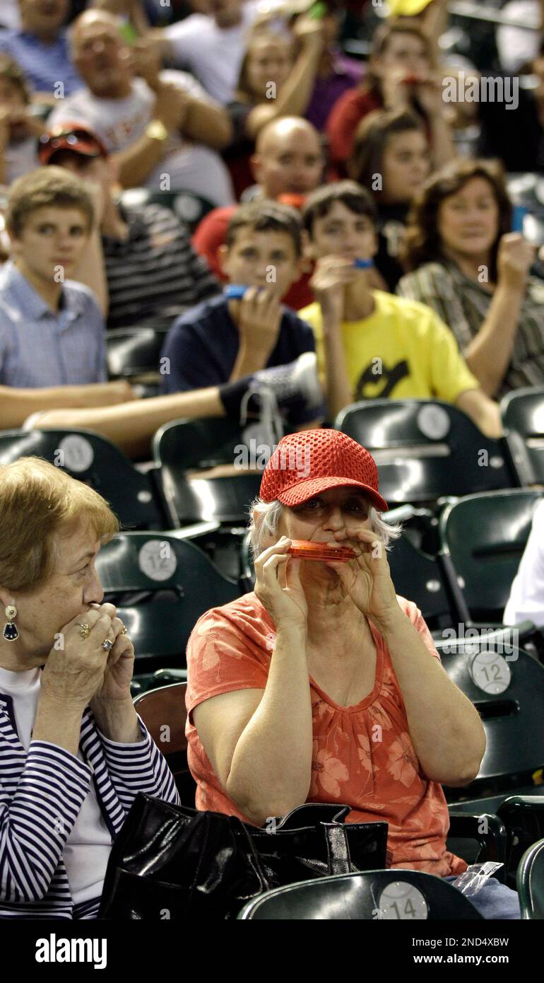 Houston Astros fans play their harmonicas during an attempt to