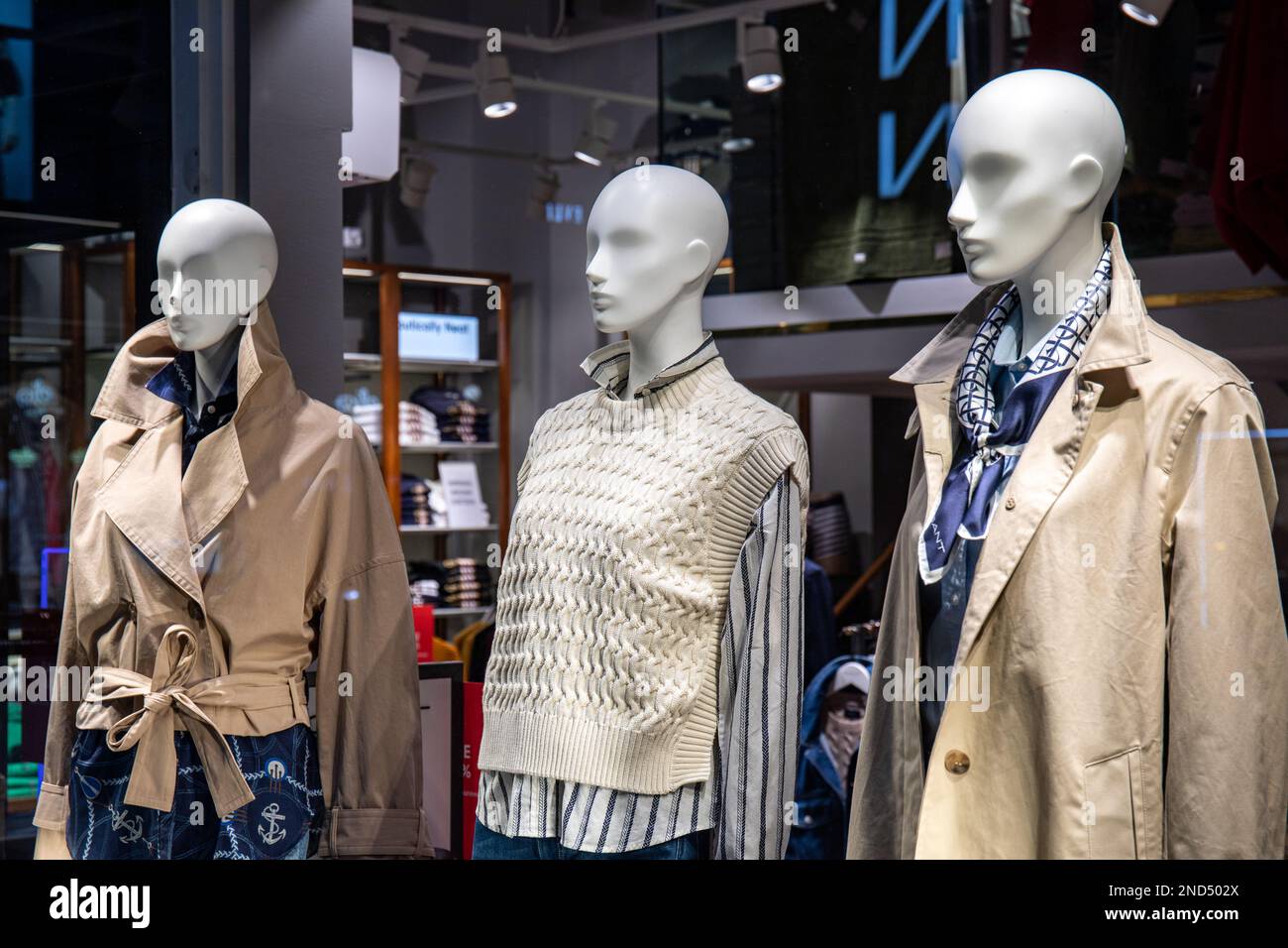 Mannequins in clothing store display window Stock Photo