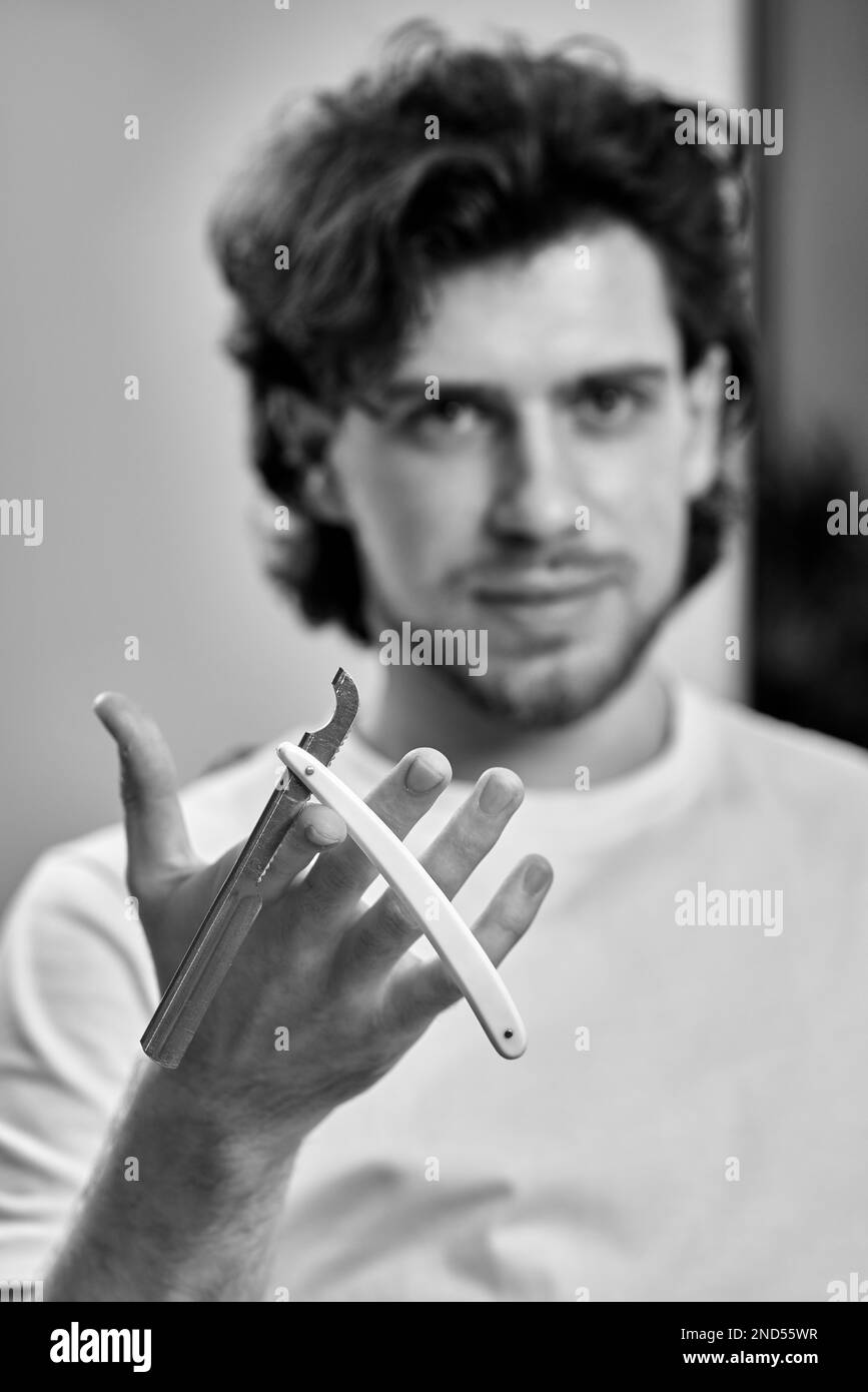 barber testing the sharpness of blade before cutting Stock Photo Alamy