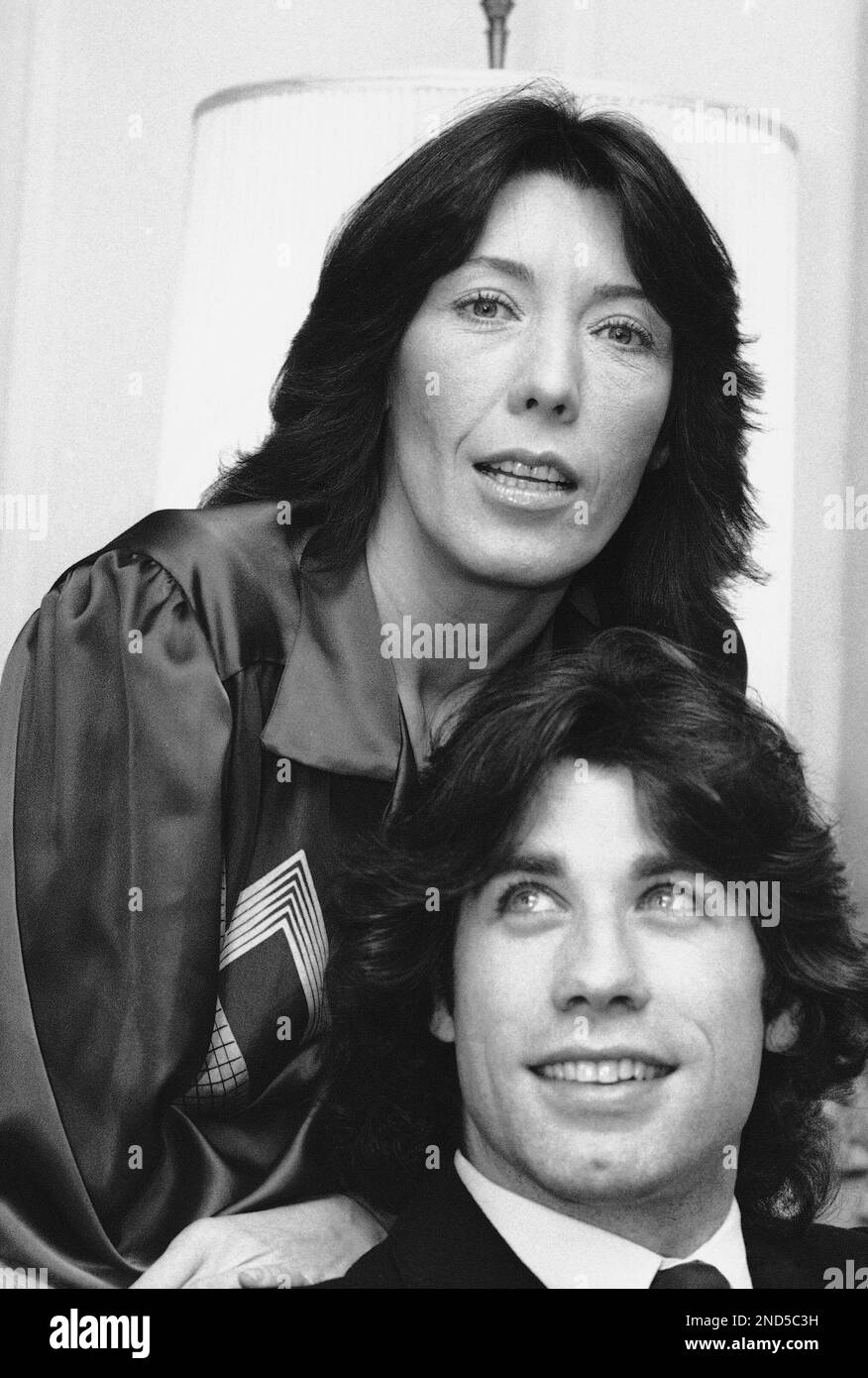 Lily Tomlin and John Travolta pose in Waldorf suite, New York, Dec. 14, 1978 in connection with