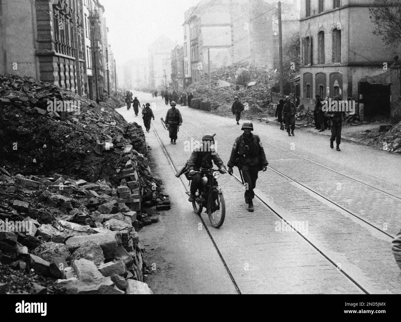 Doughboys of the 5th Infantry Division, third U.S. Army, led by a GI ...