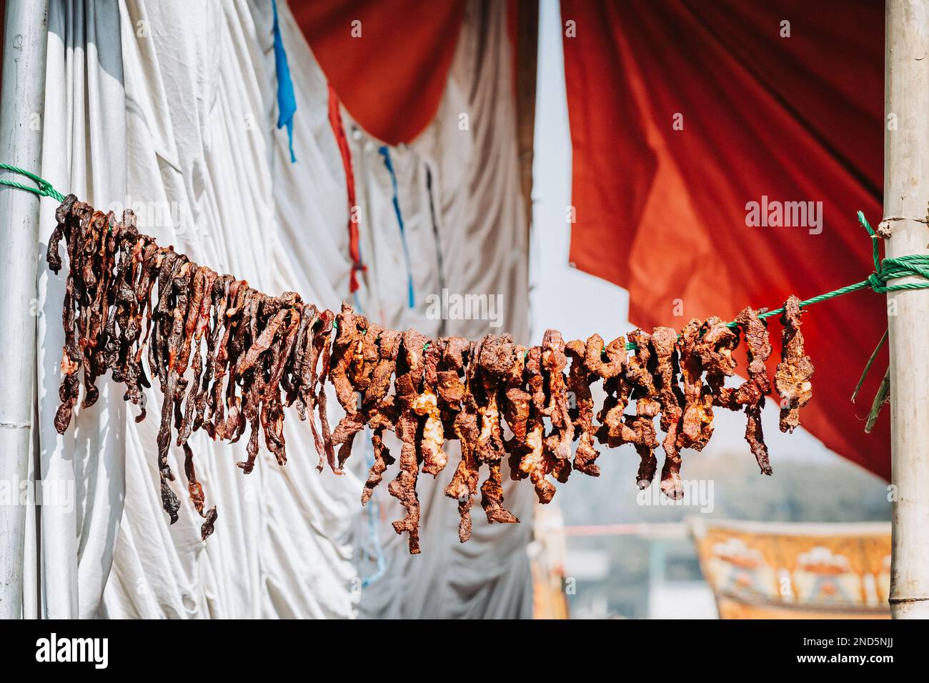 Sukuti or dried meat hanging on a rope. Selective focus Stock Photo