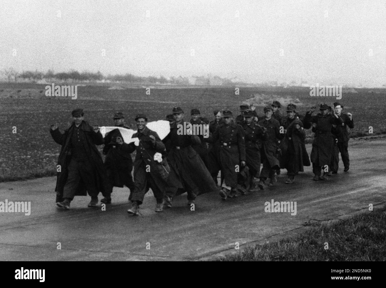 Carrying surrender flags and wearing happy surrender smiles, a group of ...