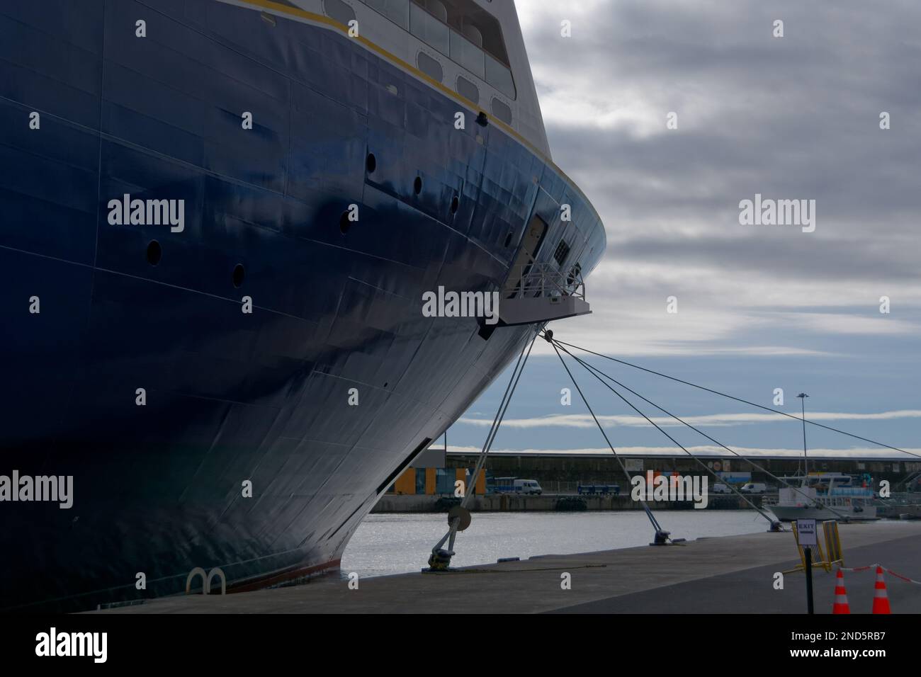 Cruise Ship bow mooring lines holding it in place showing how many are used. Dramatic image of ship's bow. Stock Photo