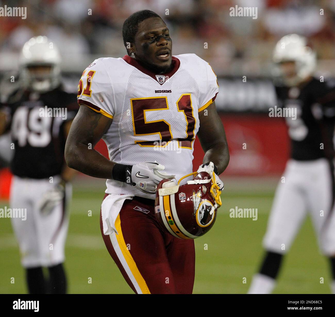 Washington Redskins linebacker Robert Henson (51) puts on his helmet