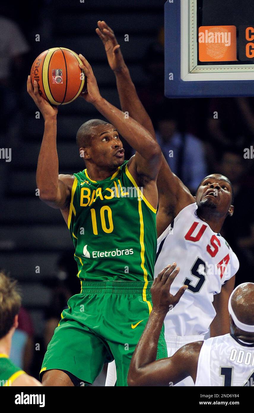 Brazil's Leandro Barbosa, left, goes up for a shot as USA's Kevin