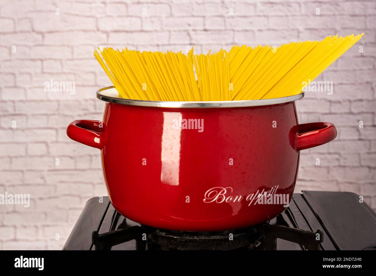cooking spaghetti in a saucepan on a gas stove. homemade Italianstyle