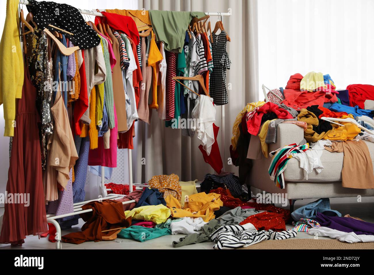 Mess of clothes all over room. Fast fashion Stock Photo