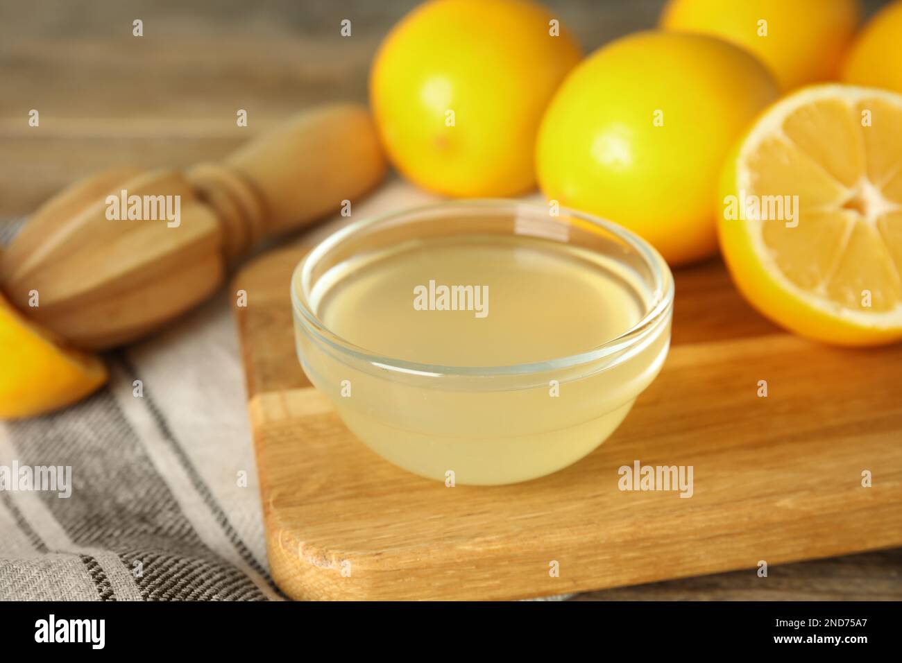 Freshly squeezed juice, lemons and reamer on table Stock Photo Alamy