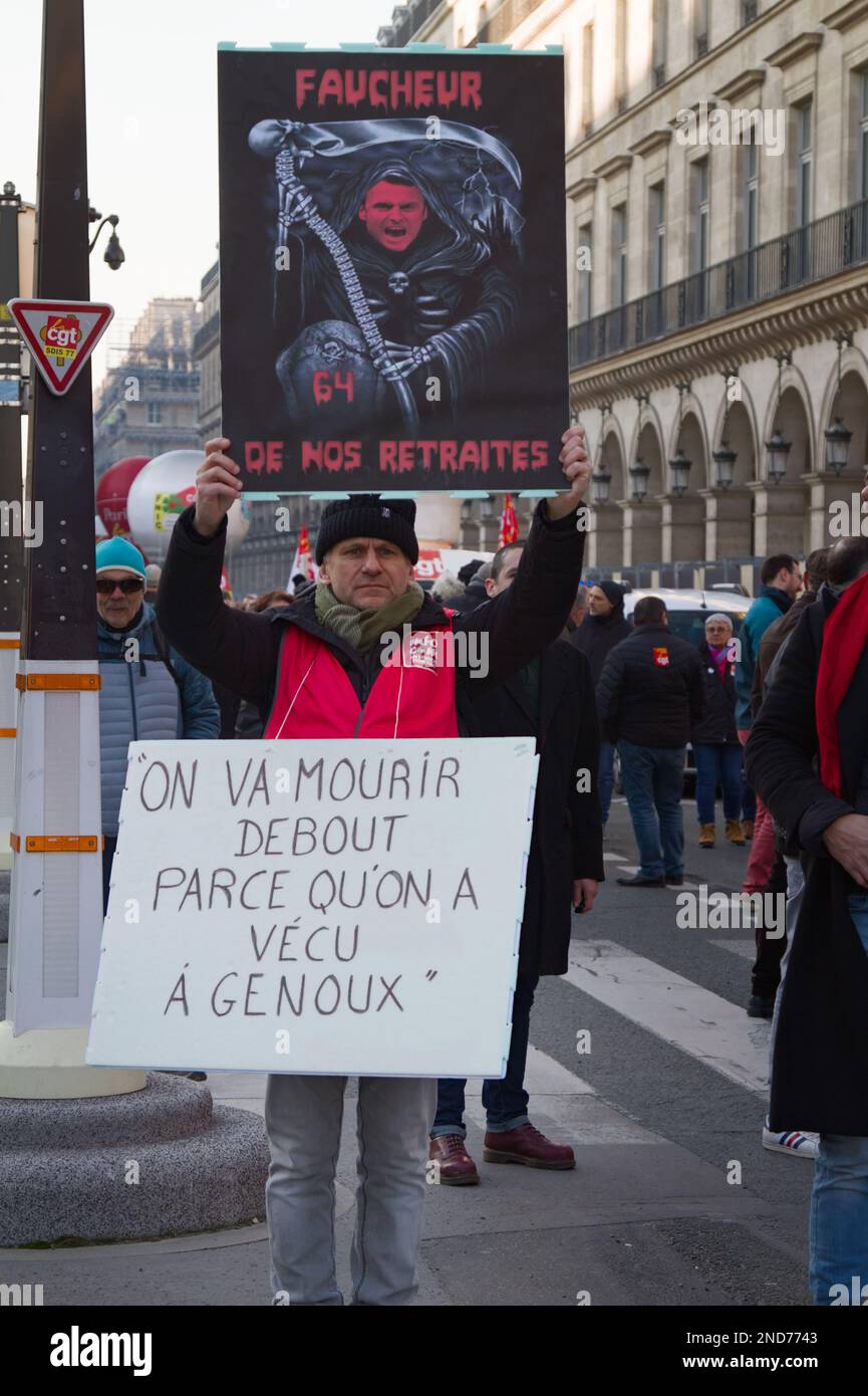 French Worker Holding A Placard With Emmanuel Macron, Protesting Against The Raising Of The Retirement Age, Paris France, 7th Feb 2023 Stock Photo