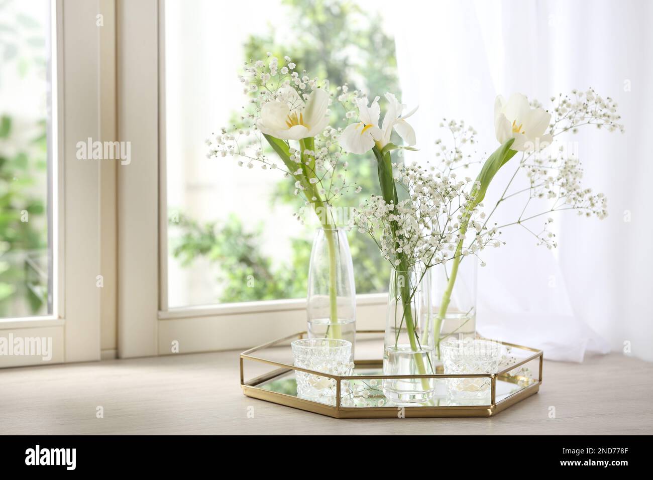 Beautiful fresh flowers on window sill indoors Stock Photo - Alamy