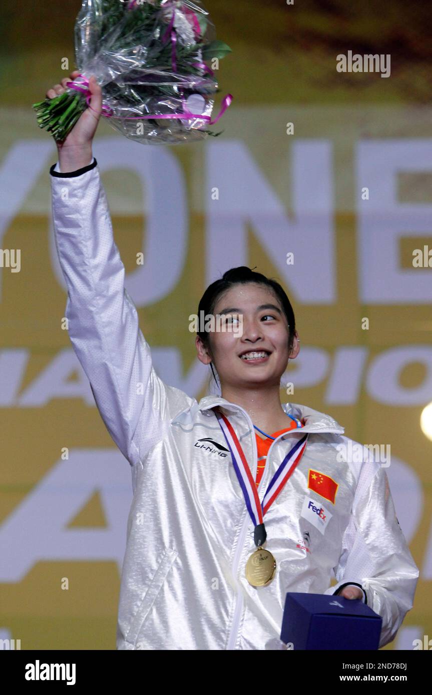 China's Wang Lin celebrate with her gold medal on the podium after