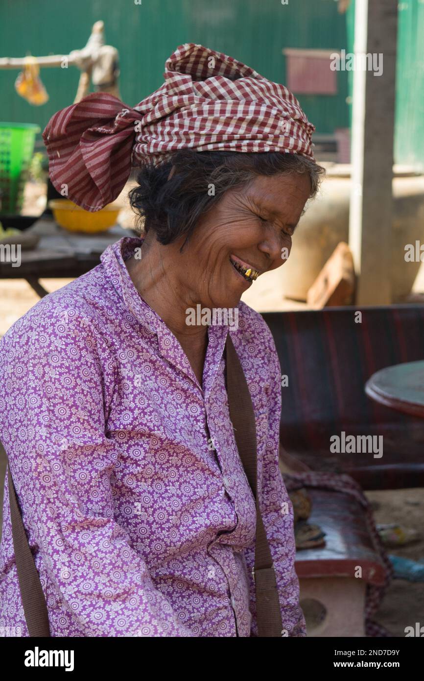 A old fish seller reacts to her picture taken. Cambodian people rely on mainly farming and fishing. Now with many young people working factories. Vill Stock Photo