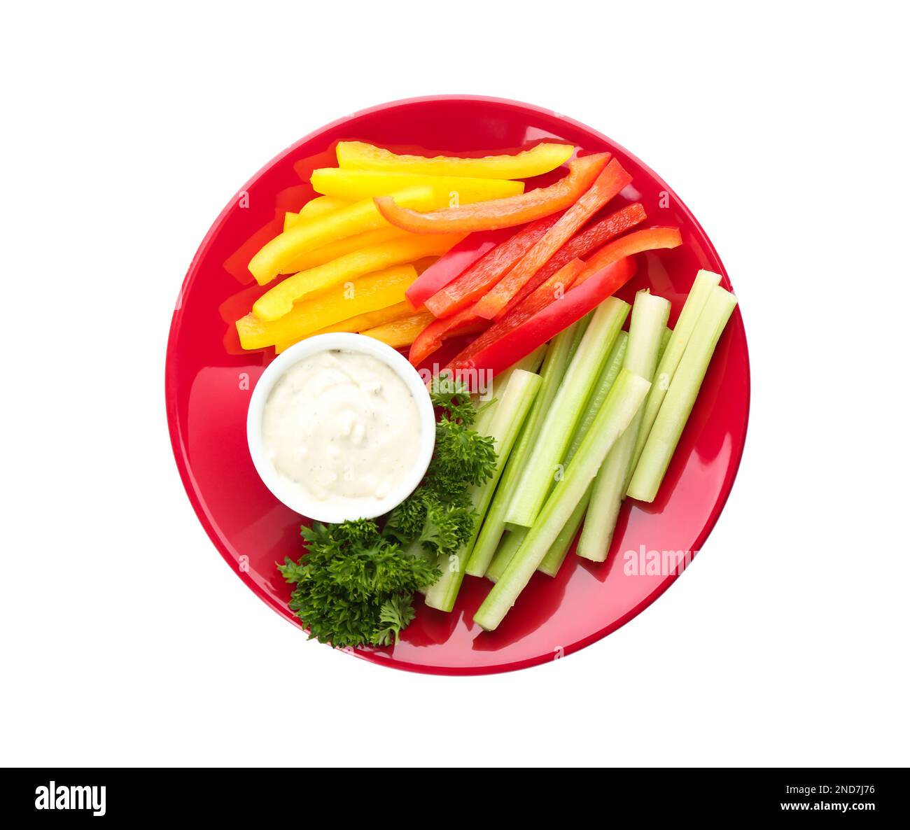Plate with dip sauce, celery and other vegetable sticks isolated on