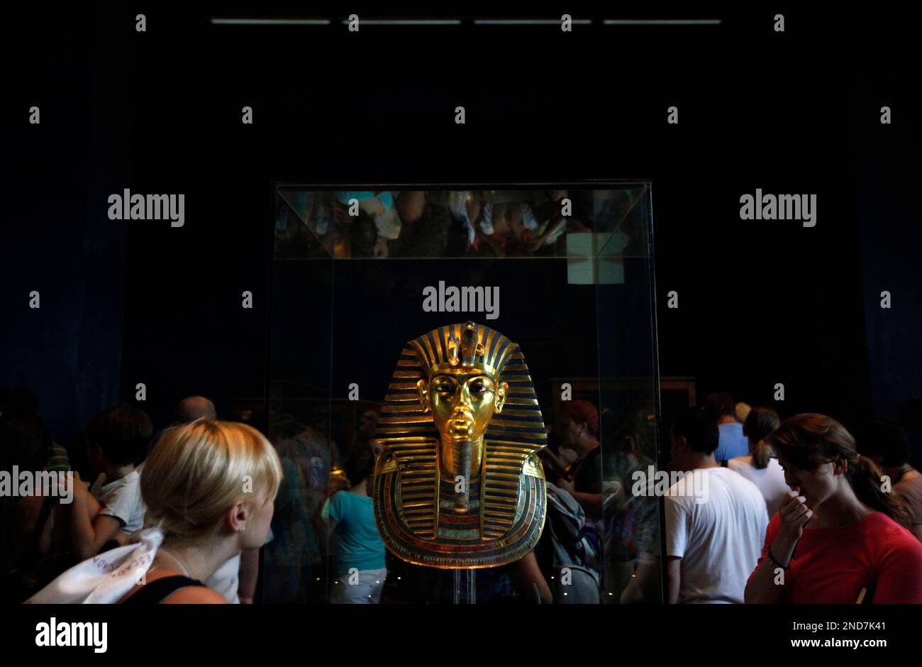 People look at the priceless golden mask of the famed King Tutankhamun