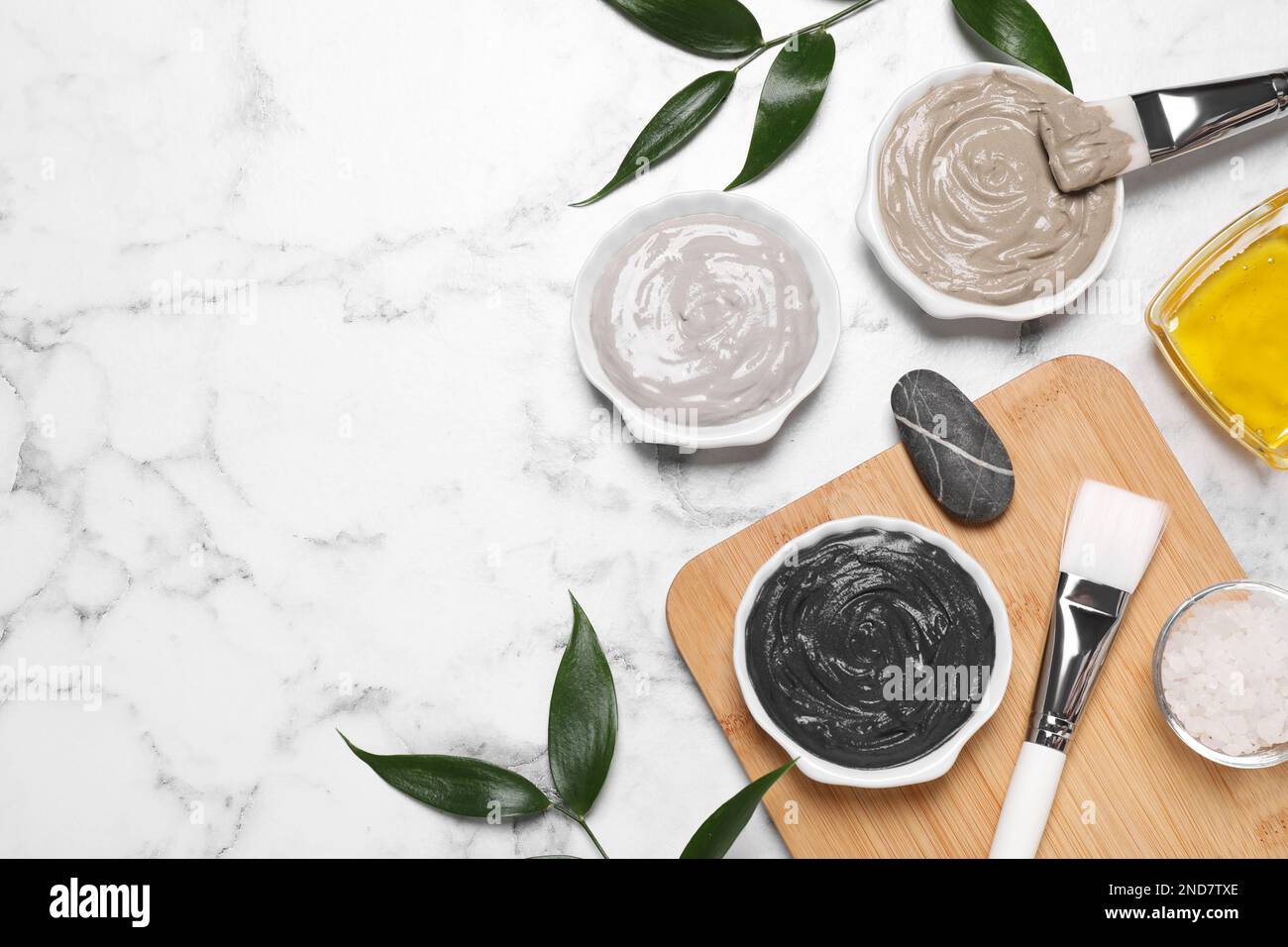 Flat lay composition with spa products on white marble table. Space for ...
