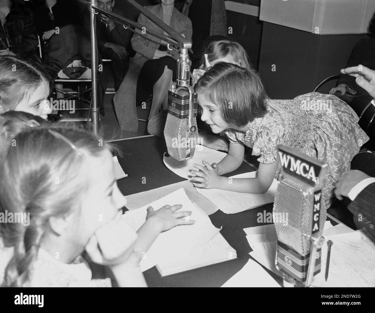 Five-year-old Anne Khuner crawls up to a microphone in a radio studio ...