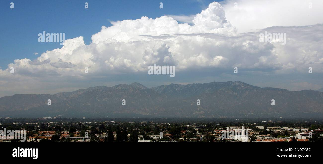 Moistureladen clouds loom up over the San Gabriel Mountains, seen from