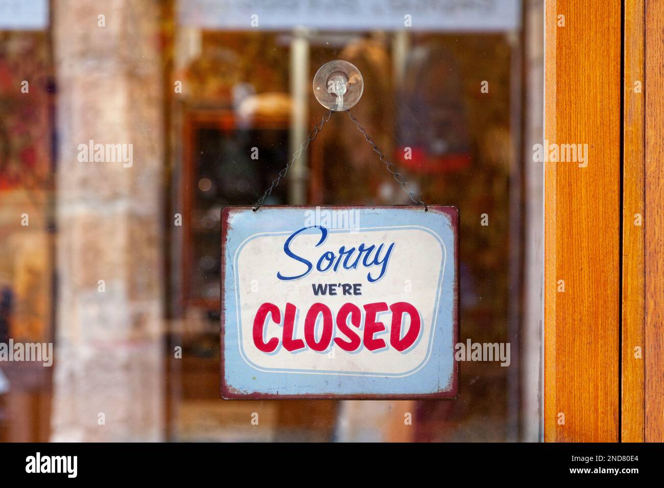Close-up on an english open sign saying 'Sorry, we're closed'. Stock Photo