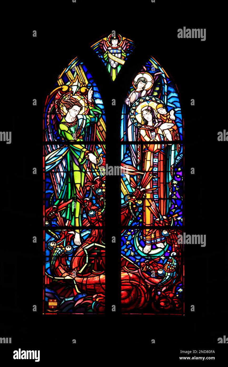 Stained glass of Michael slaying the dragon witnessed by Mary and baby ...