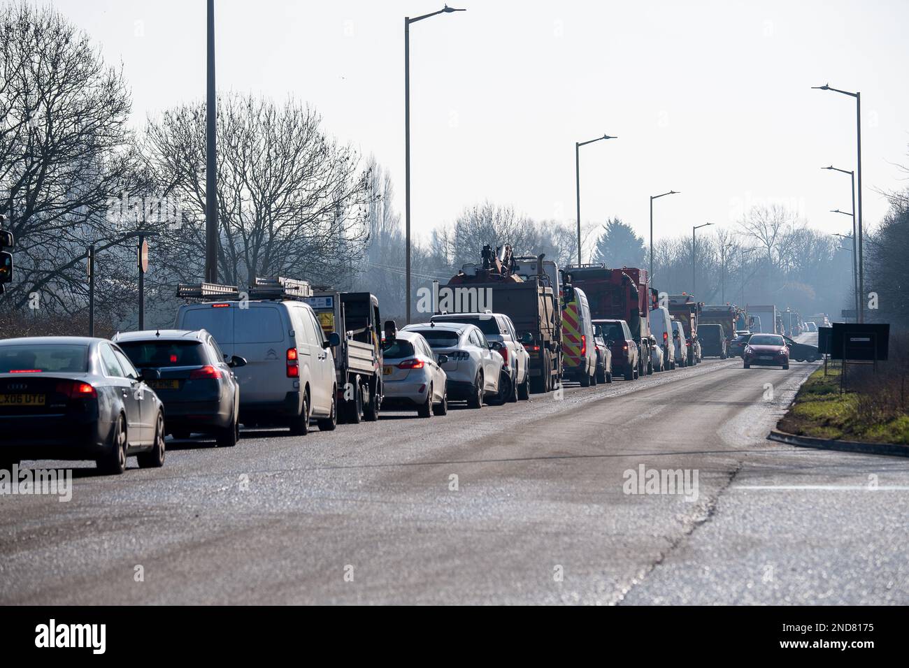 West Hyde, Hertfordshire, UK. 15th February, 2023. There were long queues today on the A412 London Oribtal Road in Denham and West Hyde due to HS2 traffic lights outside their Denham compound off the A412. A Police car with blue flashing lights was delayed and many motorists decided to turn around and go back towards Maple Cross as the queues were so long heading into Denham. HS2 contractor lorries that use the A412 were also stuck in the traffic jams. Credit: Maureen McLean/Alamy Live News Stock Photo