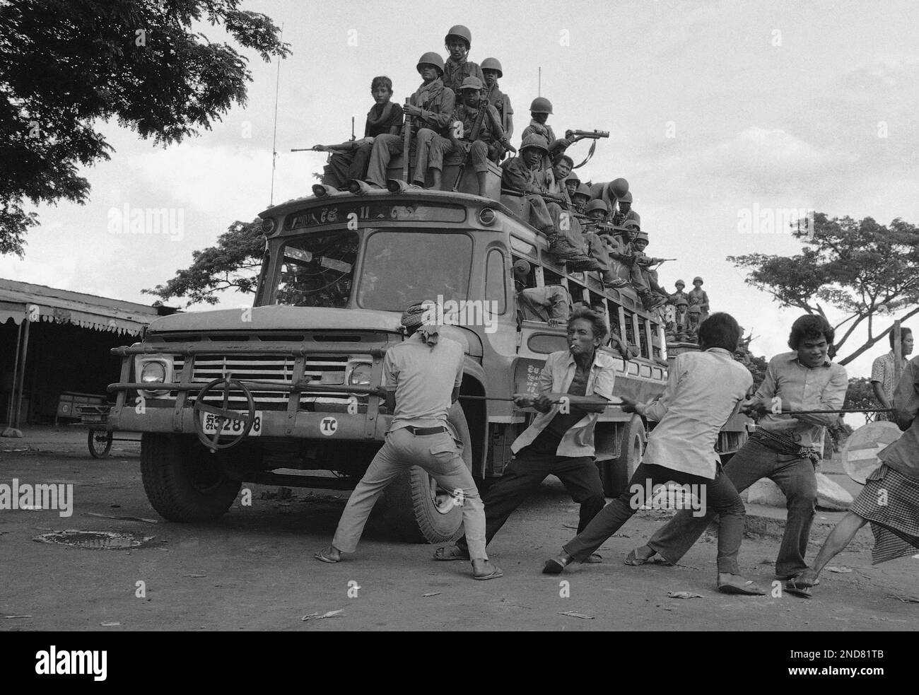 Battery dead, an army driver enlists muscular civilians to crank the