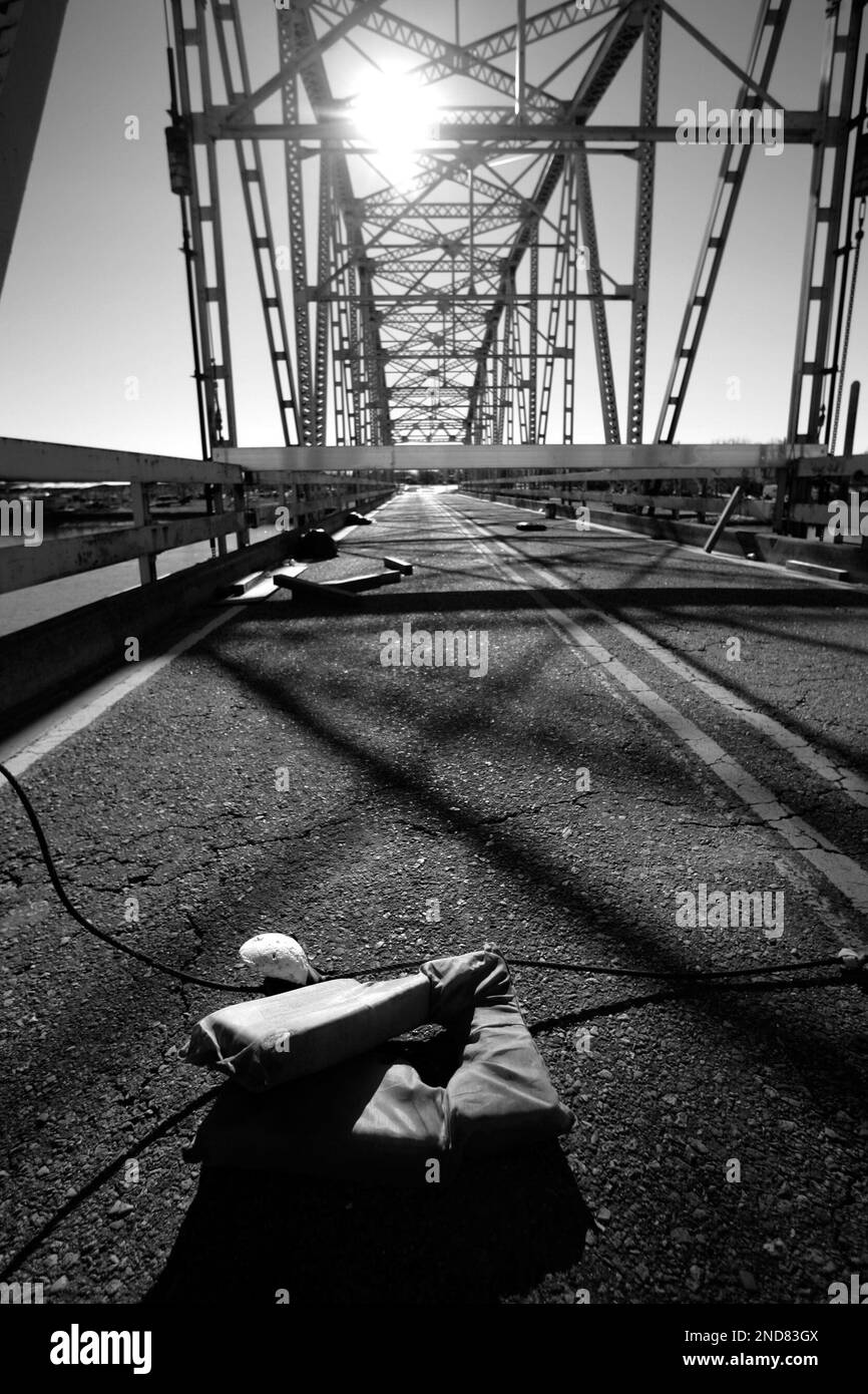 Life vests and debris litter the heavily damaged Chef Menteur Bridge on