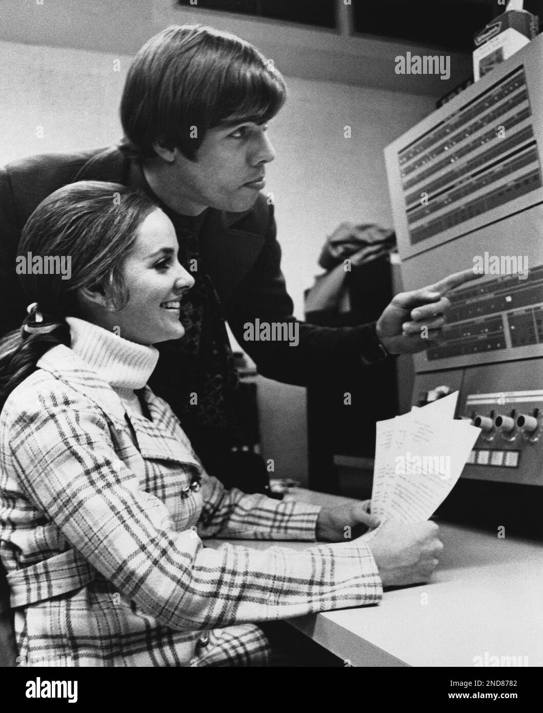 Sitting communication smiling pointing watching paper professional