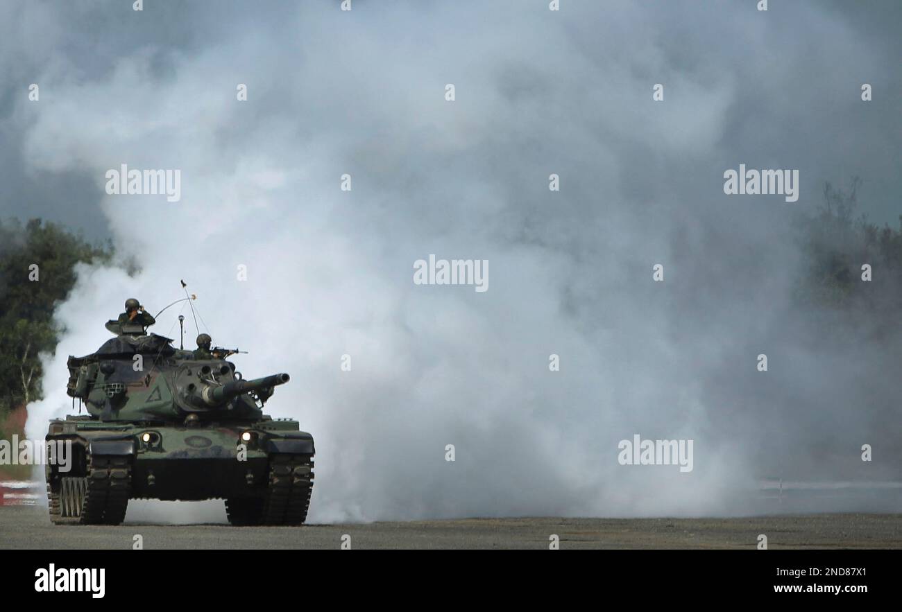 The Taiwan army armored tank division maneuver an M-60 tank through a ...