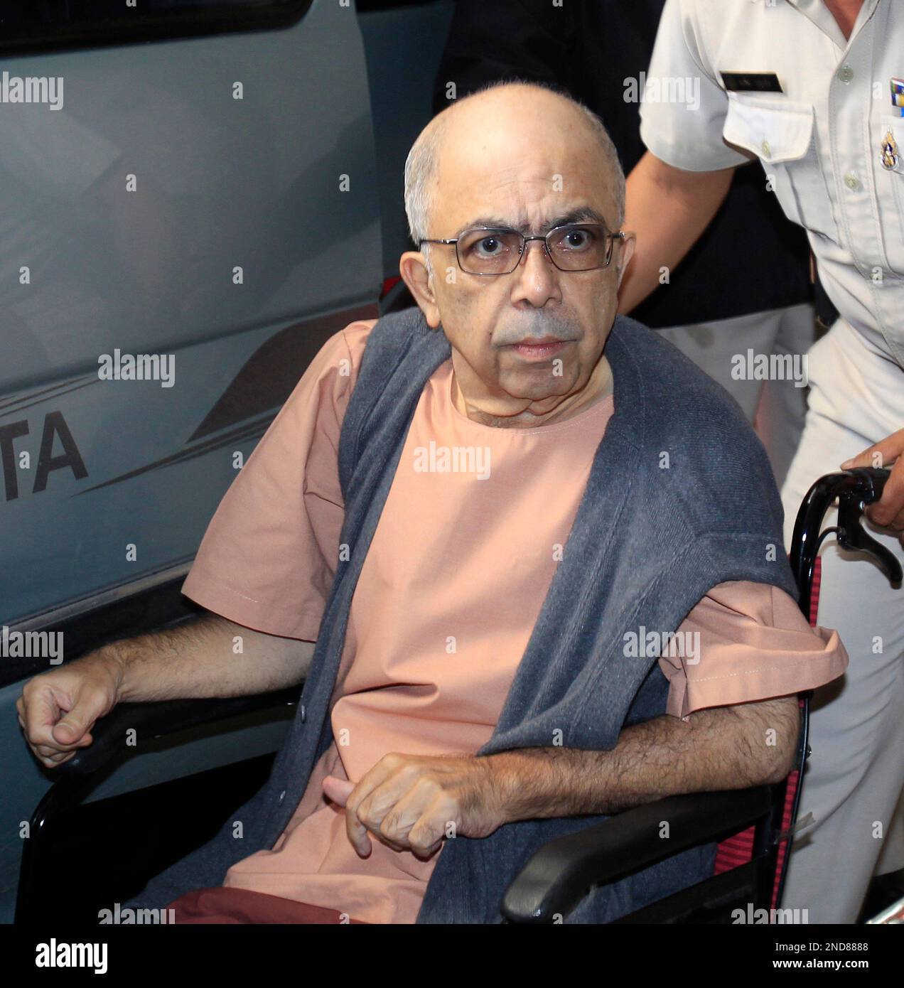 Rakesh Saxena in a wheelchair arrives at the criminal court in Bangkok ...