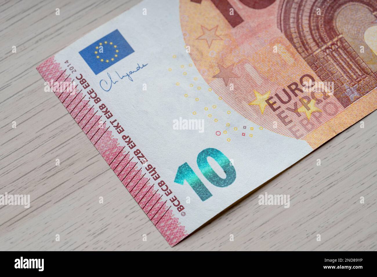 10 euro banknote close up, wooden table background for business finance ...