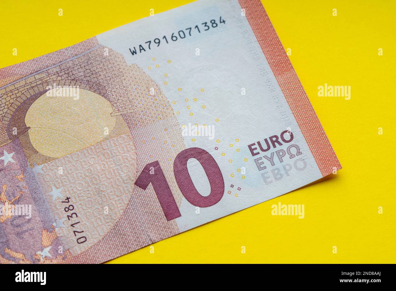 10 euro banknote close up, yellow background for business finance ...