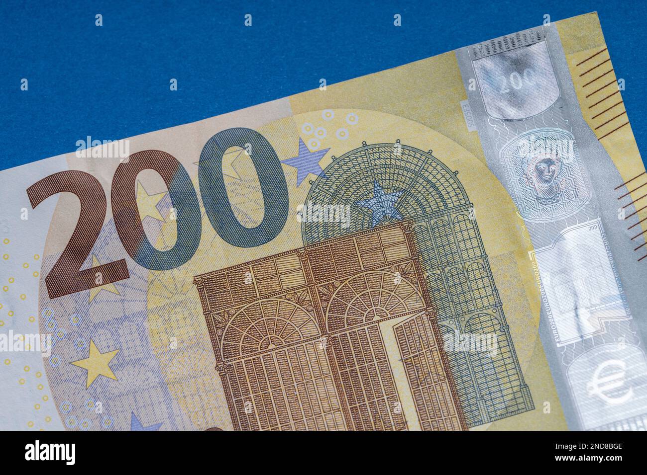 200 euro banknote close up, blue background for business finance topics ...