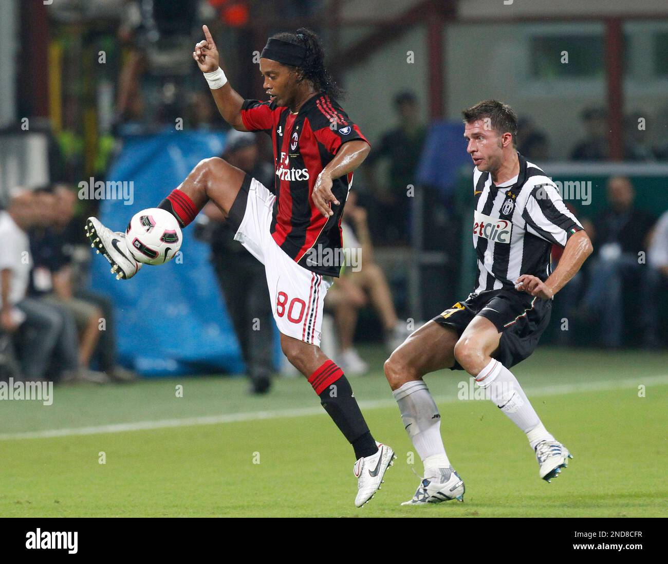 AC Milan Brazilian forward Ronaldinho , left, controls the ball as ...