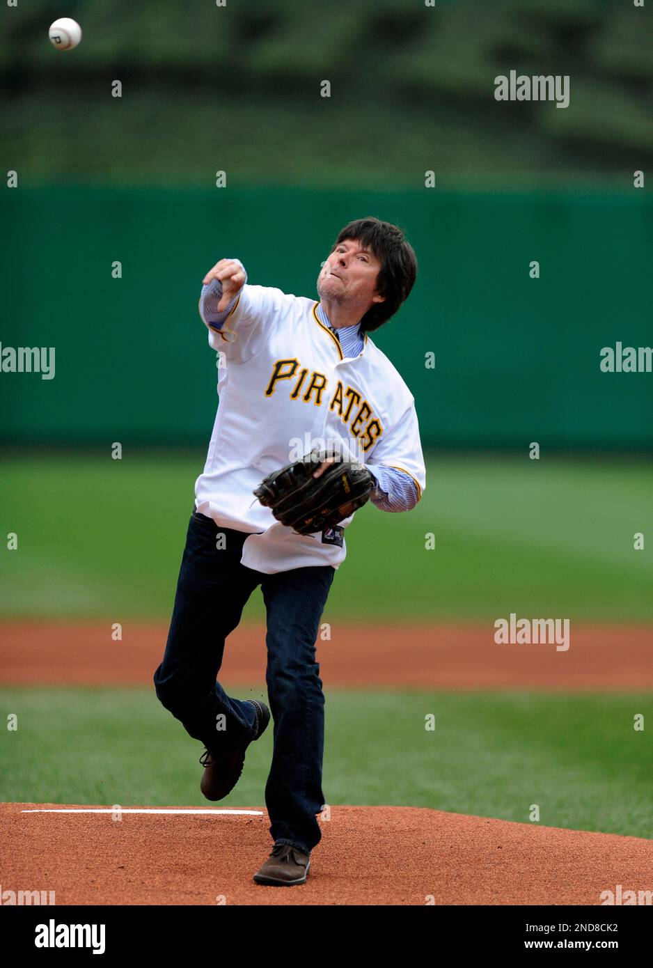 Documentary filmmaker Ken Burns throws out the ceremonial first pitch before a baseball game between the New York Mets and the Pittsburgh Pirates, Sunday Aug