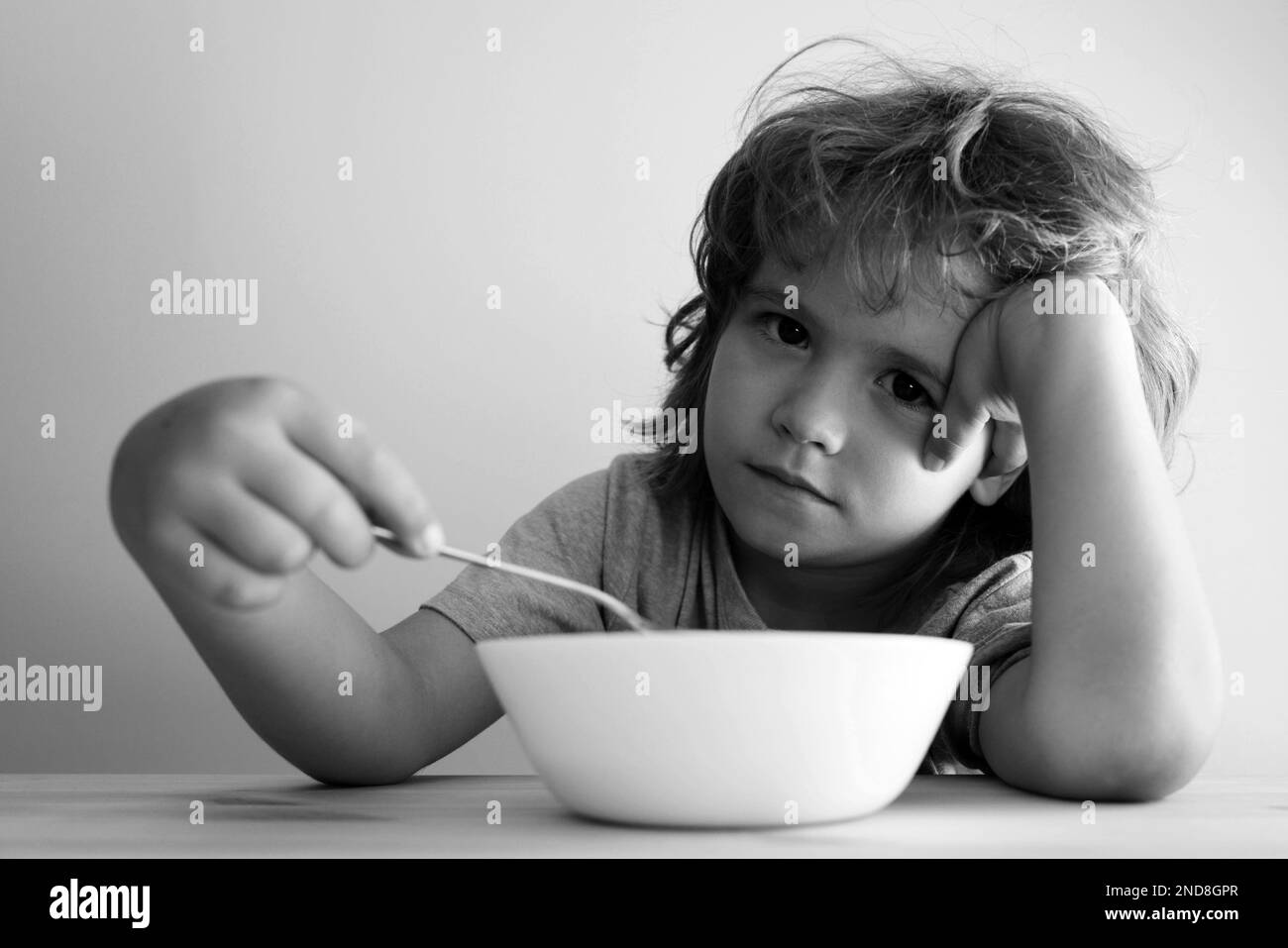 Boy does not want to eat a pasta with cutlet. Little boy does not want to eat. Stock Photo