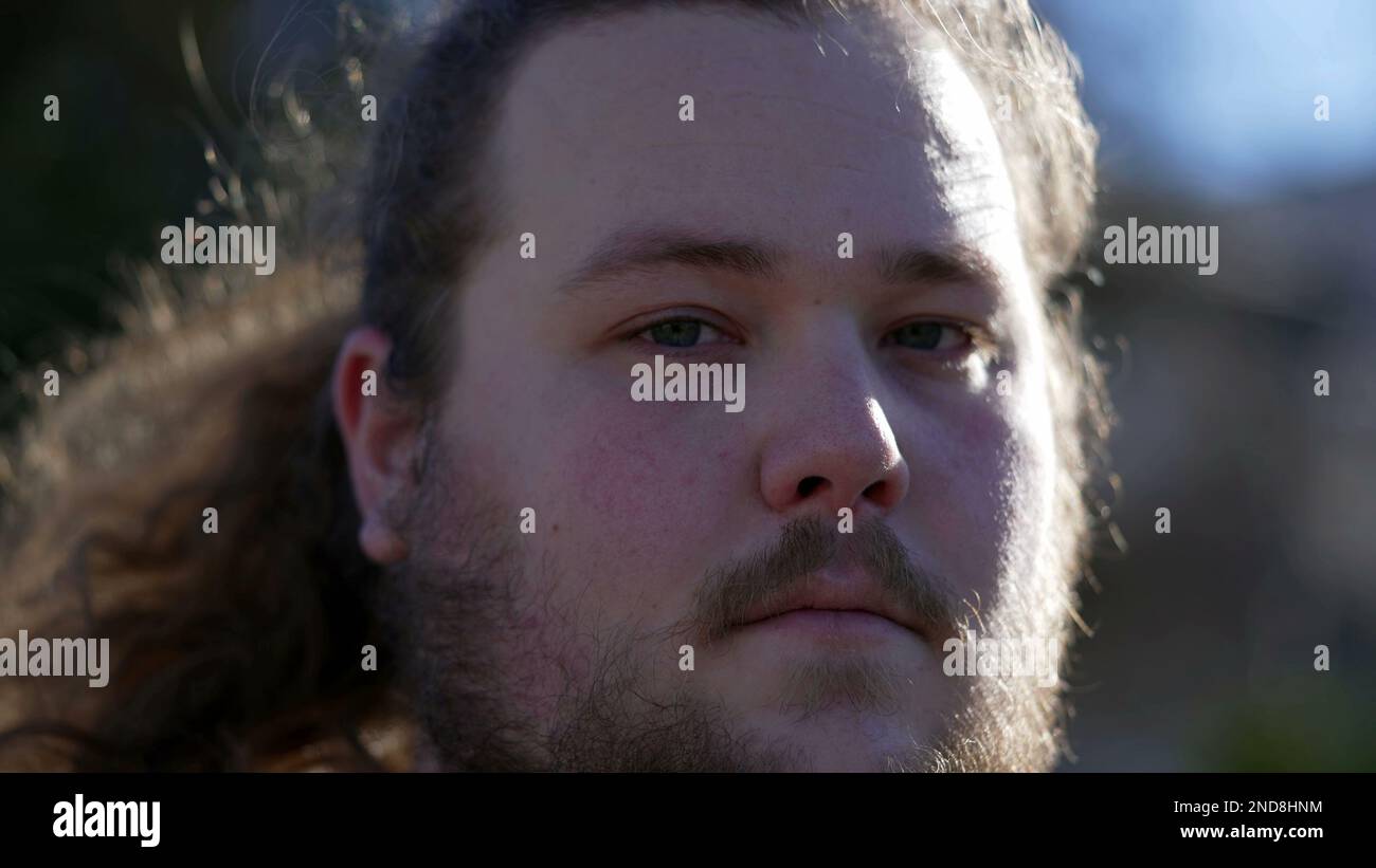 Portrait of a chubby young man face in extreme close up in tracking ...