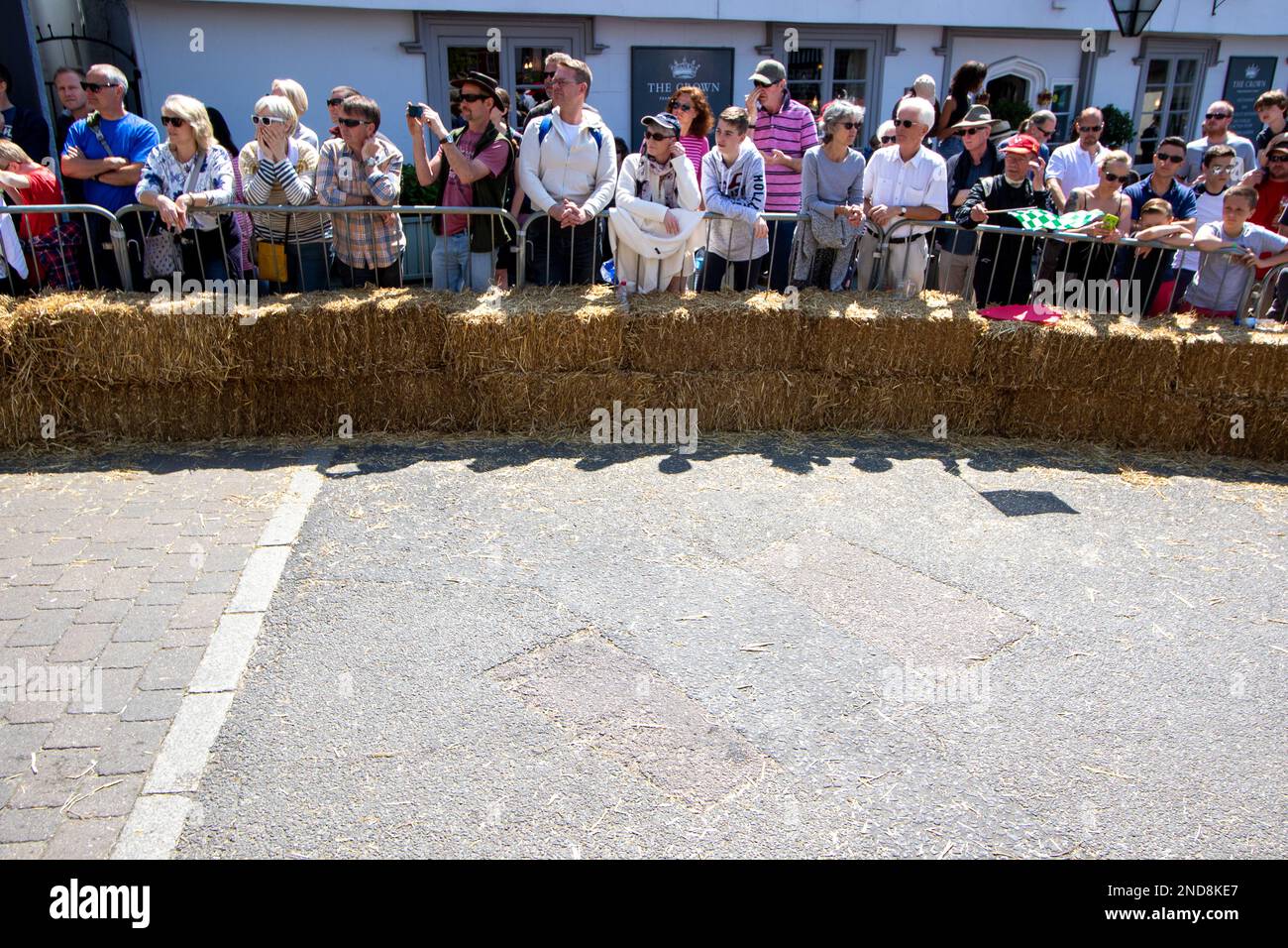 Strawball Racing Spectators behind straw bales watch downhill soapbox racing from the ...