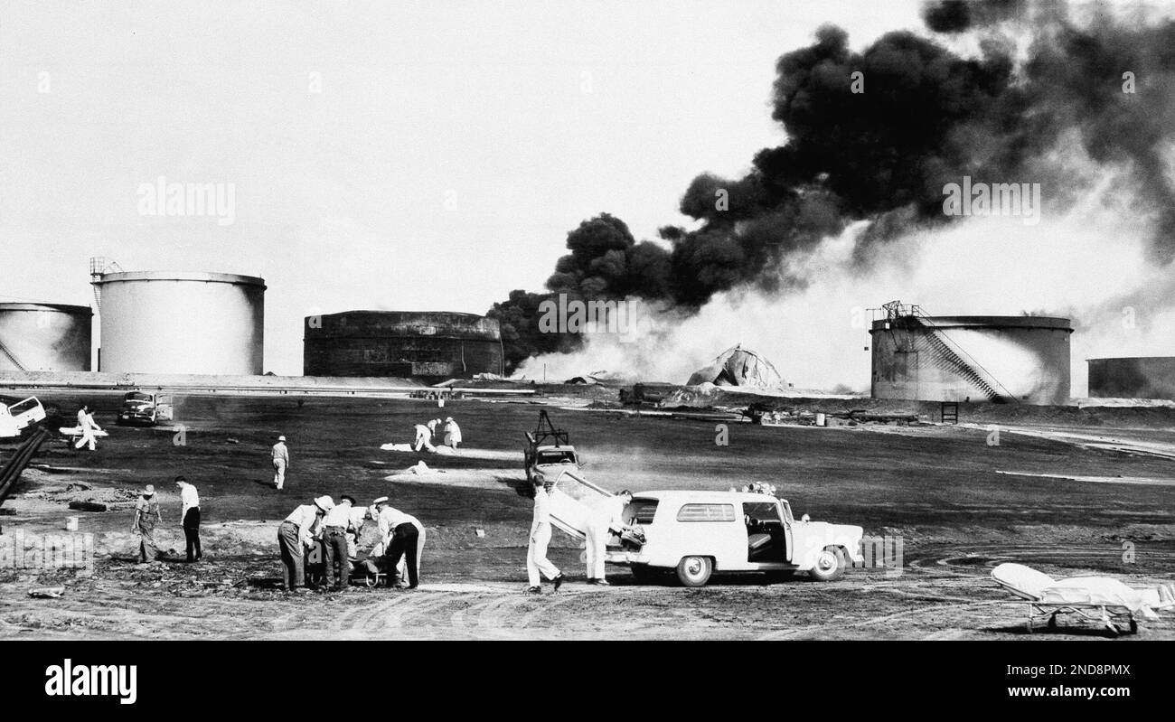 Heavy black flames pour from the tank which exploded at Shamrock Oil