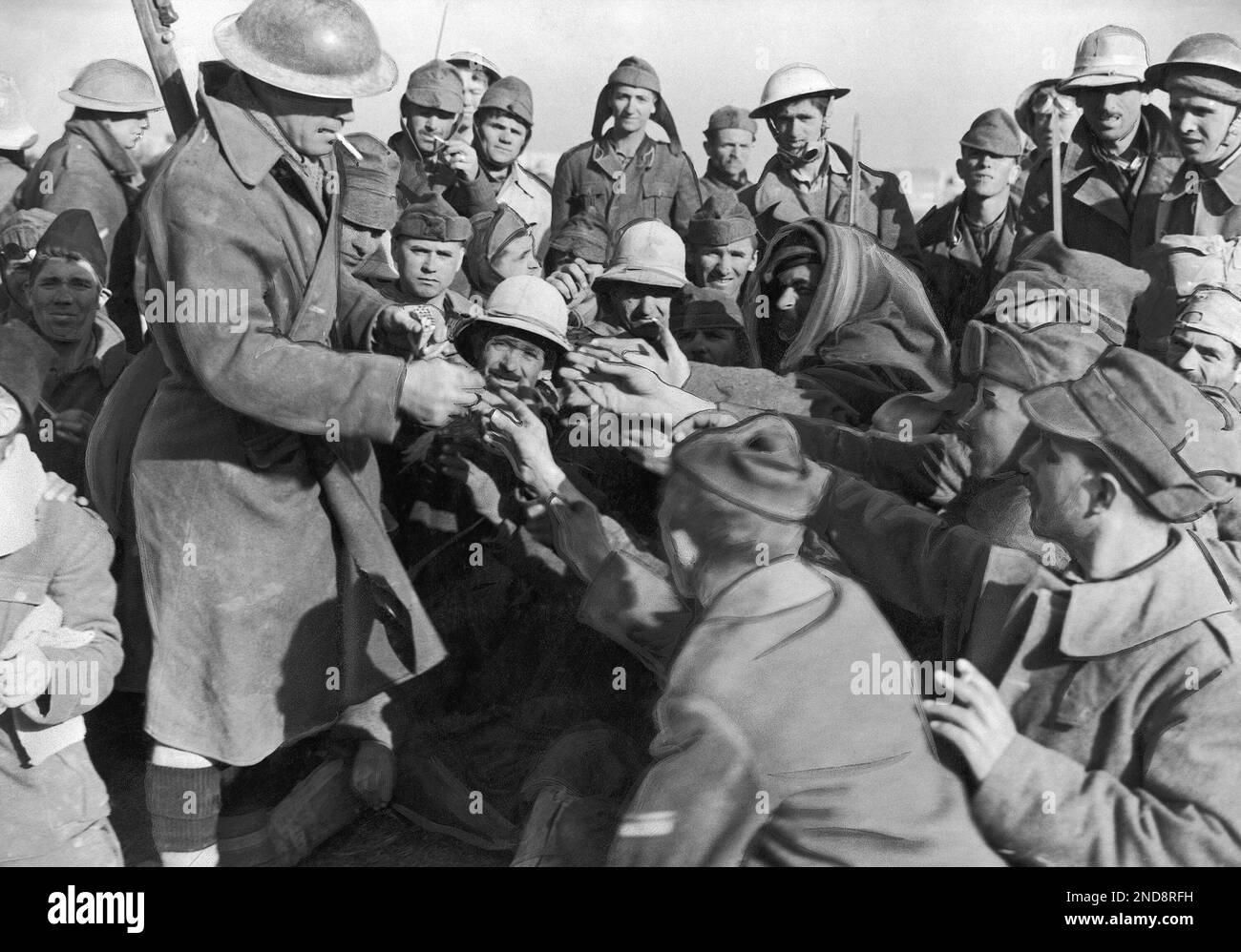 Italian prisoners captured in Britain’s North African campaign extend their hands to receive