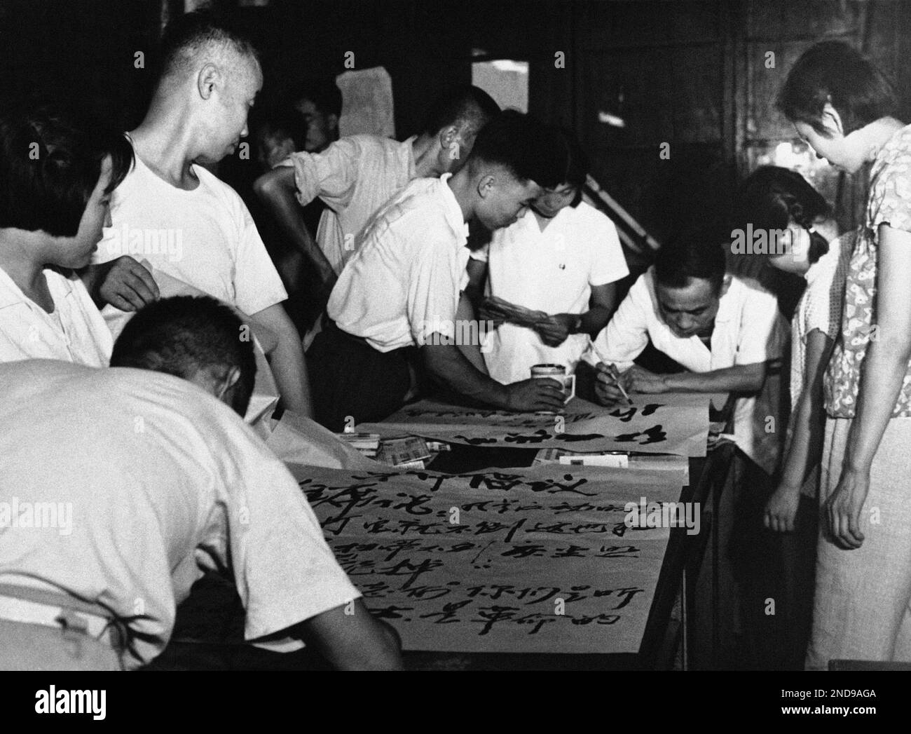 Workers for the Red Guard movement use a Peking residence as they paint posters supporting the