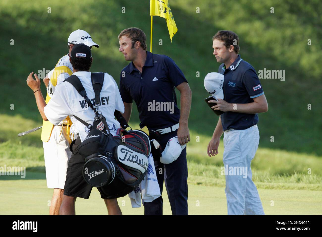 Nick Watney, right, Dustin Johnson, center, shake hands with their