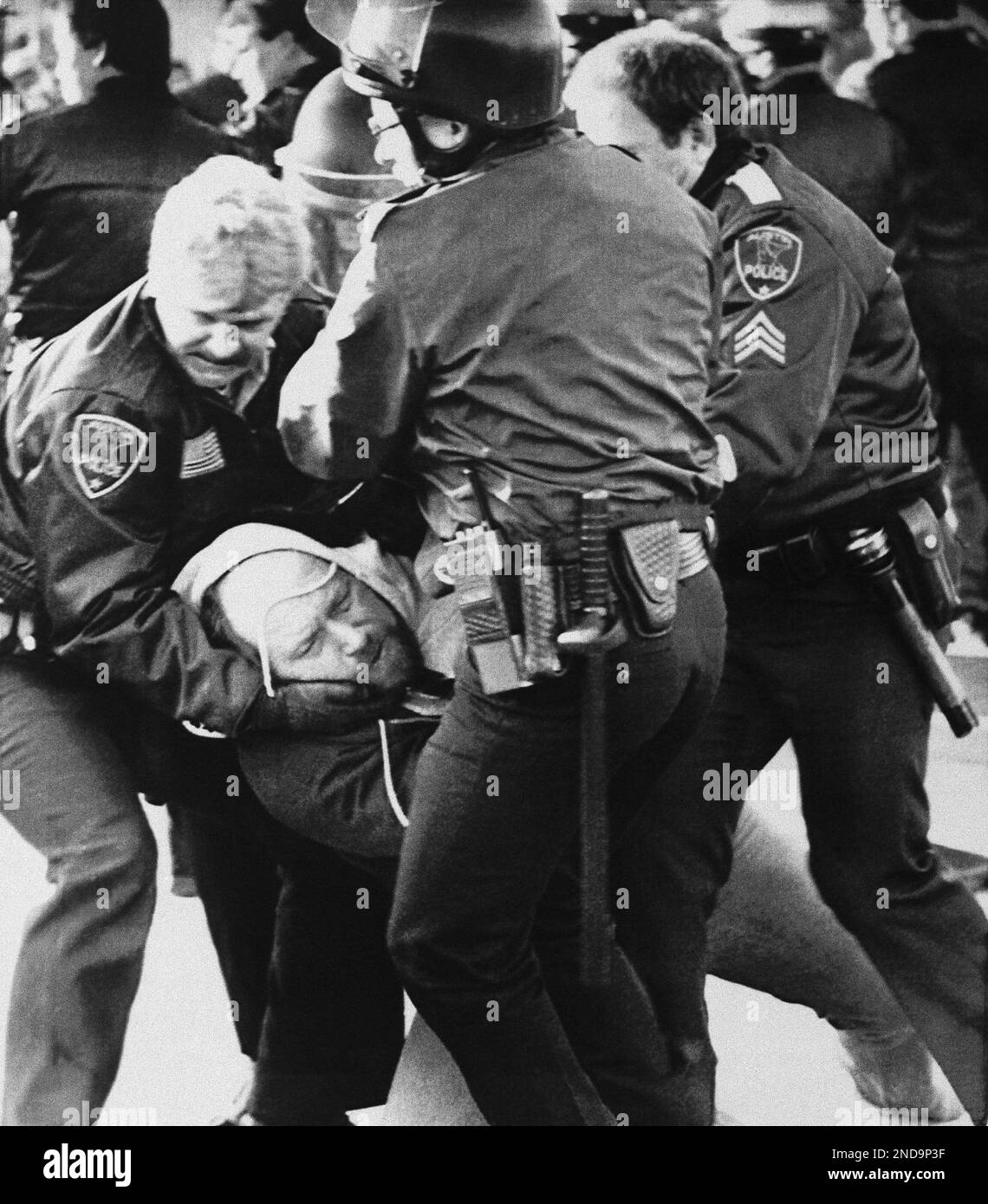 Police remove a protester from the barricade set up in front of the