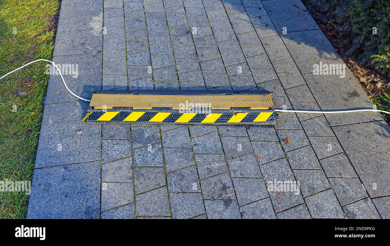 Outdoor Cable Protector Safety Device Cover at Tiled Pavement Stock