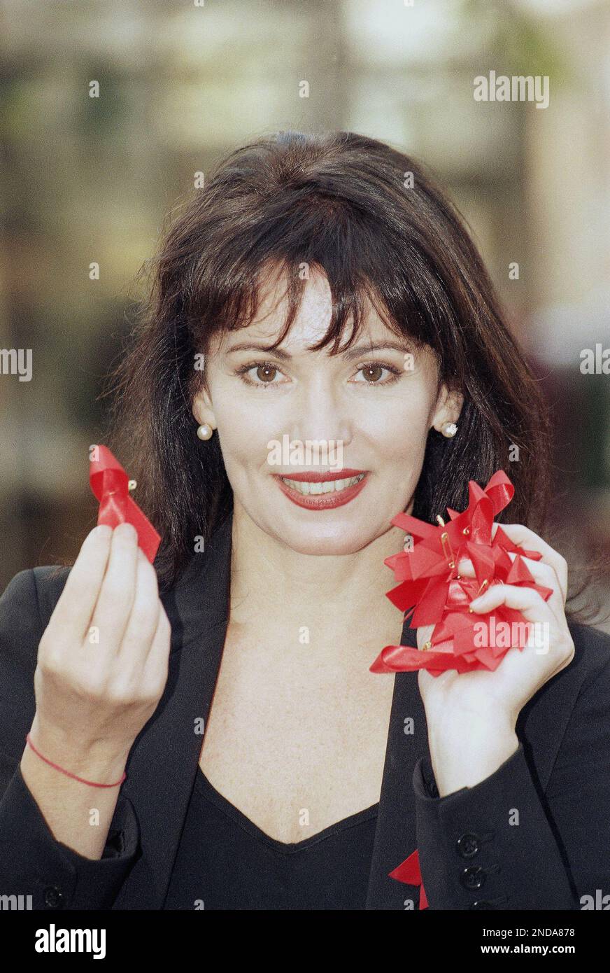 German actress Iris Berben shows red AIDS awareness ribbons on November ...