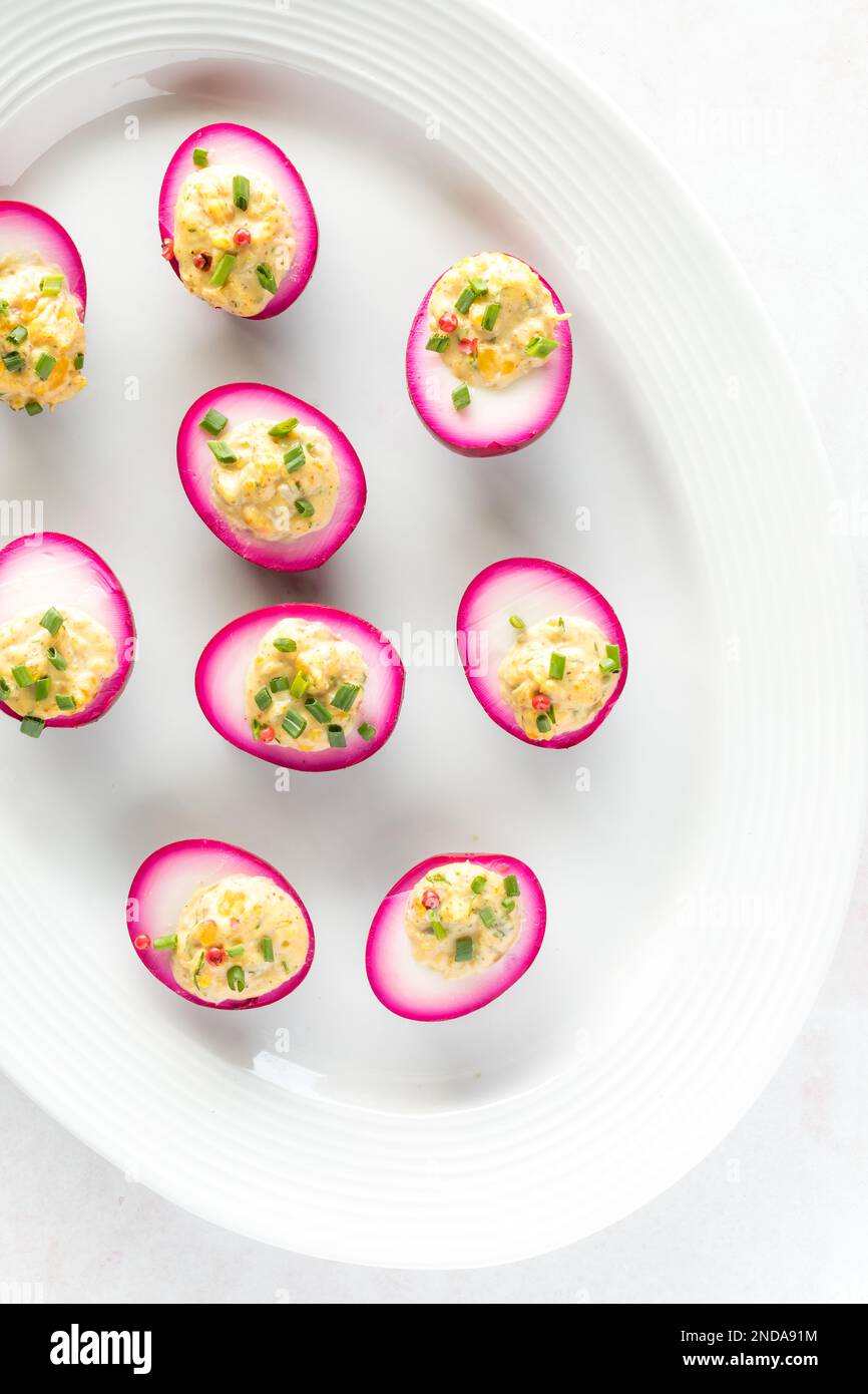 Top down view of a platter of beet juice dyed Deviled eggs, ready for eating Stock Photo Alamy