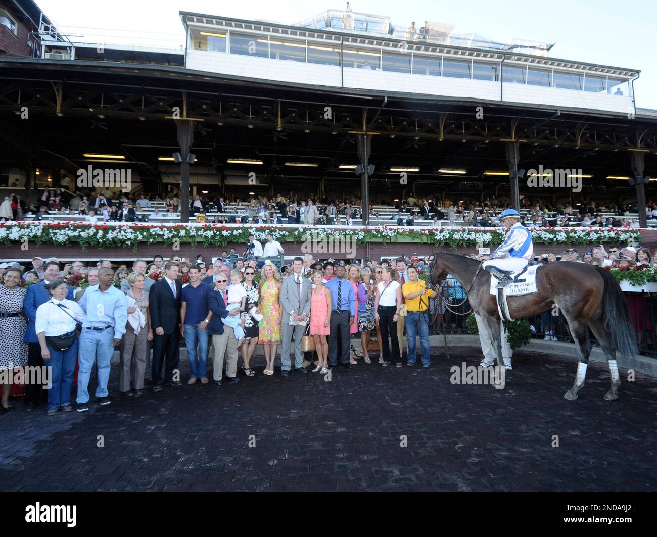 Blame with jockey Garrett Gomez ,right, in the winners circle after the Whitney Handicap horse