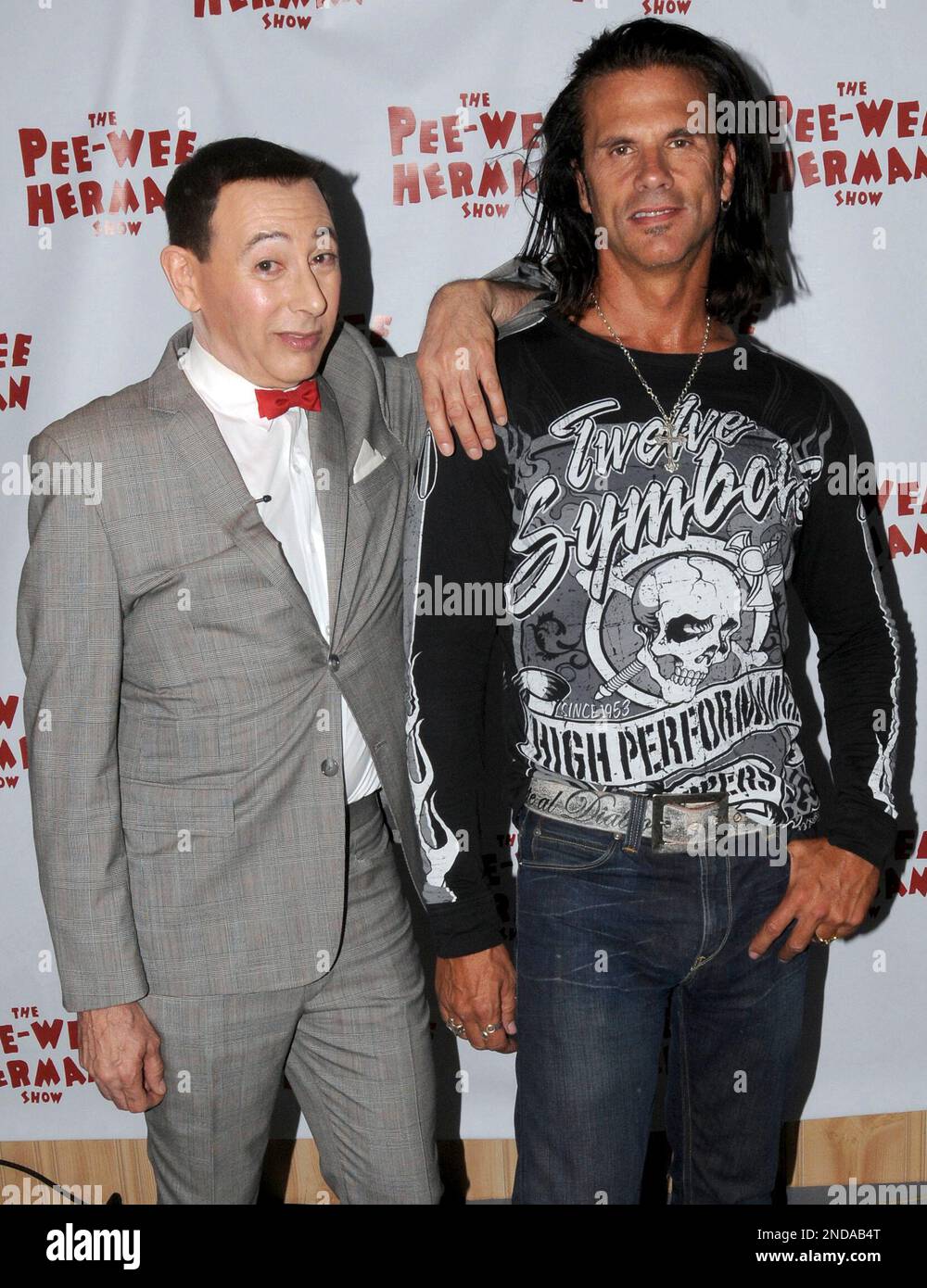 Comedian Paul Reubens, left, in the character of Peewee Herman, poses