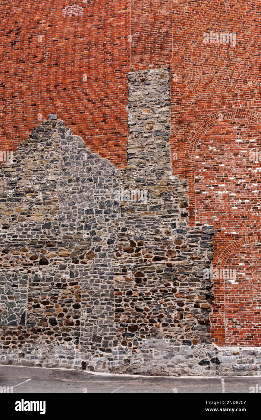 Canada,Quebec,Montreal,outline of old house in fieldstone as part of a red brick building in downtown Montreal Stock Photo