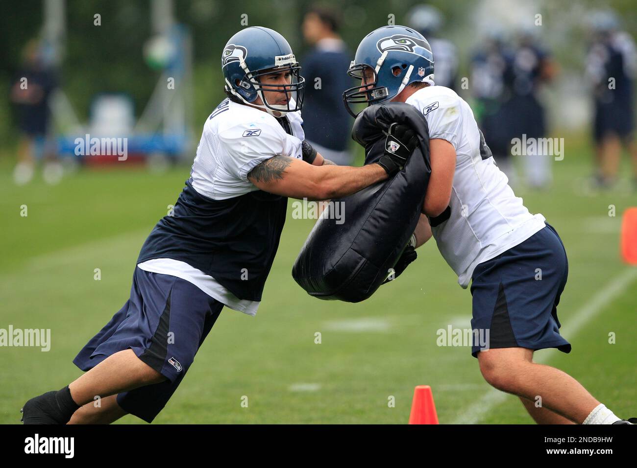 Seattle Seahawks' Lofa Tatupu, left, in action during a NFL football  practice Monday, Aug. 2, 2010, in Renton, Wash. (AP Photo/Elaine Thompson  Stock Photo - Alamy